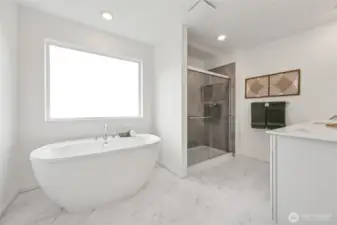 Primary bathroom with a spa-inspired soaking tub, dual vanities, tile shower, separate toilet room, and walk-in closet.  Picture for representational purposes only, colors and features may vary.