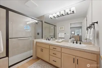 Large shower with bench and double sinks; private water closet
