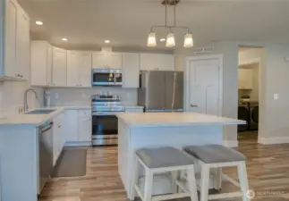 Lots of cabinet space... utility rooom and exit to garage to the right of the pantry.