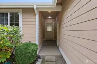 Walkway to the front door with side-door to garage.