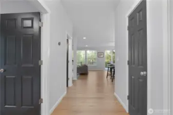 Standing at the front door looking into the home towards the treed backdrop