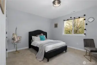 One of two spacious secondary bedrooms. Ample space for a queen size bed and a desk.