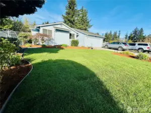 Front of home with yard, driveway has off-street parking for 5+