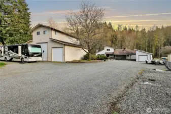 Expansive shop, with unfinished upper apartment, sits on the front part of the property. Off street parking for everyone!