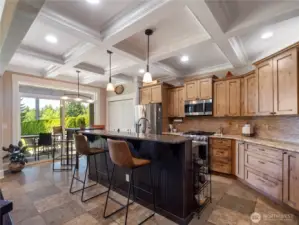 Beautiful wood cabinetry, granite slab counters, stainless steel appliances, gas range and breakfast bar.