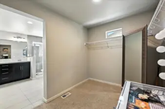 Spacious primary walk-in closet.