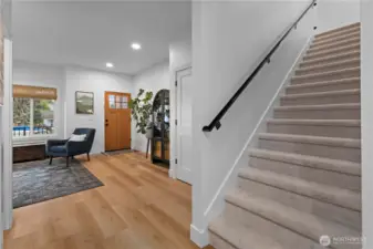 Reverse angle of the entry area and view up the stairs to the upper level private spaces.
