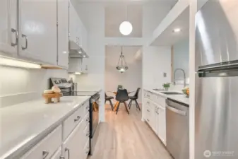 Completely updated kitchen with granite countertops, high ceilings, new appliances, luxury vinyl plank floors and open to living and dining rooms.