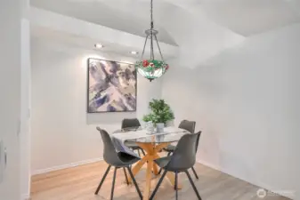 Dining room with high ceilings and luxury vinyl plank floors.