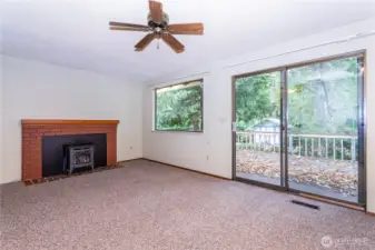 Family room, with propane fireplace insert, slider to spacious rear deck overlooking mature landscaping