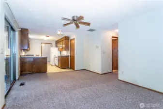 A view from the southside of the family room to the kitchen, at far left, slider to rear patio.