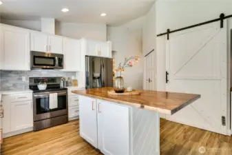 This stylish barn door has an extended pantry space on one side, and a beautiful beverage/coffee or wine bar on the other side.