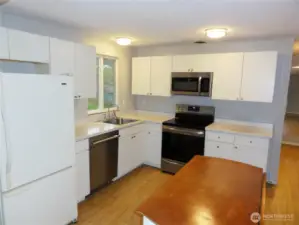 Plenty of cabinets and counterspace here. Island and stainless appliances.