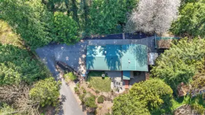 Aerial shot showcasing property and metal roof.