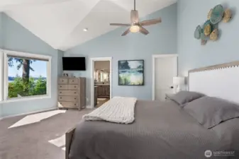 Vaulted ceiling in primary bed, door on the right leads to walk-in closet.