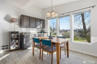 Spacious dining room with additional built in kitchen cabinets.