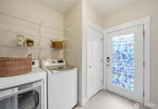 There is a side door entry from outside into the laundry room.