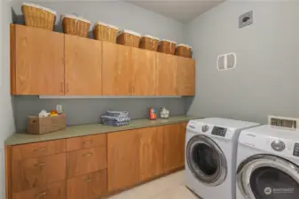 As a former model home, the laundry room is bigger than other units, with great cabinet storage