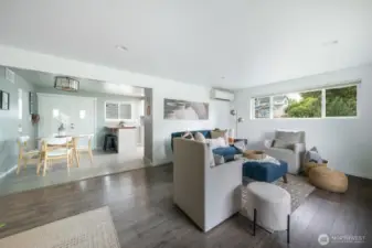 The living room seamlessly connects to the kitchen and dining areas, creating an effortless flow for everyday living and entertaining.