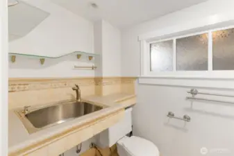 Half bath on lower level has outline of where a shower may have previously existed. Plenty of room to add shower.