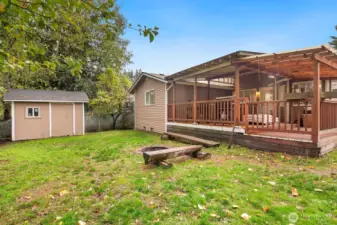 Backyard with large storage shed and firepit!