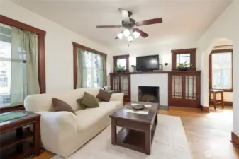 Large Living room with original hardwood trim brings warmth and cozy comfort to the space.