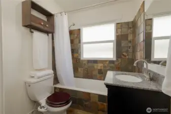 Main floor bathroom with slate floors and surround slate enclosure.