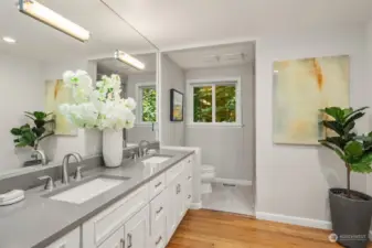 Primary bathroom has been recently remodeled and features a standing shower, large vanity with double sinks and access to the walk-in closet. Updates include new countertop, sinks, fixtures, lighting and fresh paint.