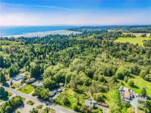 Viewing  west south from Harborview Road frontage where 8.9 acres would be accessed (between farmhouse with grey roof on left and parcel with round structure on right. i.e. bottom center of photo.