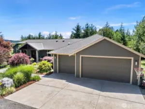 There are 4 car spaces, on of which is tandem. That tandem space has a garage door that opens to the yard, perfect for your toys & riding lawn mower.