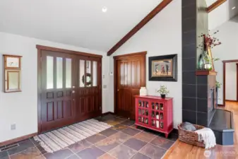 Double door entrance to stone floors & 12' ceilings.