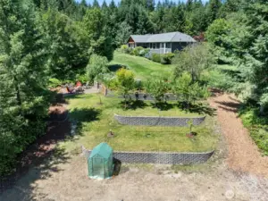terraced with fruit trees at the top. Fire-pit is there to the left