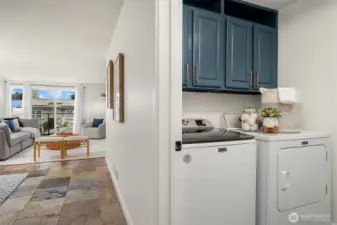 An oversized laundry room features full-size washer/dryer, pantry shelving, and space for a  deep freezer (included). Additional storage includes a walk-in entry closet and a 130-cu-ft  private storage room in the secure garage.