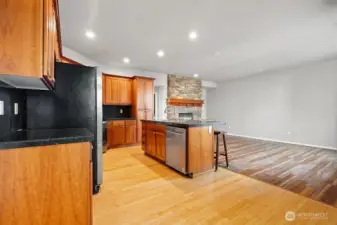 Spacious kitchen showcasing stainless steel appliances, rich hardwood floors, gleaming granite countertops, and so much more—perfect for both everyday living and entertaining.