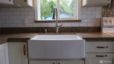 Apron sink with a wide mouth faucet