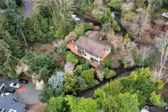 View of back of home with upper and lower decks.