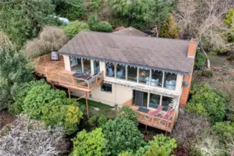 Better view of the exterior of the home. Living room and dining room across front of the home. Lower deck off family room.