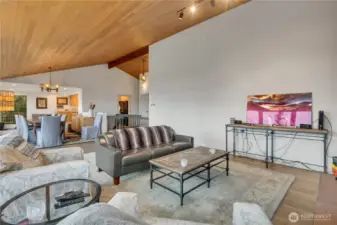 Living room viewing open stairwell and dining area.