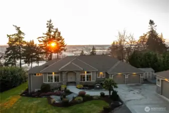 Stroll the walkway past the stunning water feature and enter through the double door entry into this 2016 custom built home.  This estate is equipped with efficient geothermal heating an cooling, heated floors, and forced air climate control across seven separate zones for maximum comfort.