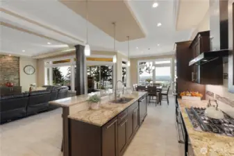 Gourmet kitchen features granite bar, eating area, gas range, double oven and walk in pantry
