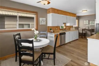 View of dining room into the kitchen. You can also see the breakfast nook on the other side of the kitchen.