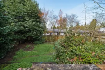 Backyard setting with mature greenery and natural privacy, creating a quiet outdoor environment.