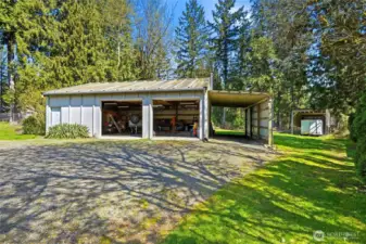 Featuring a massive 1,080 sq ft detached shop with heated workspace, extra refrigerator, 10x30 enclosed tool shed, 12x28 carport, and 15x29 covered RV parking
