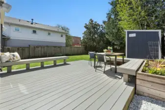 Large, sunny composite deck with a wonderful grassy fenced backyard.