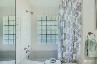 Beautifully tiled and bright shower/tub.