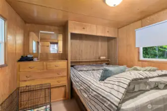 The bedroom has built in cabinets. The bed could be moved to allow access to the closet.