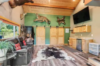 Family room with wet bar. Laundry is behind the barn doors,