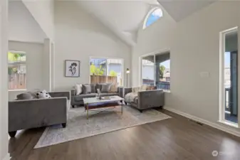 Entry with vaulted ceilings, big windows that fill the living space with natural light.