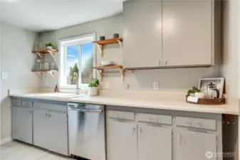 Stylish open shelving complement the natural light from the window. No lack of storage in these classic cupboards!