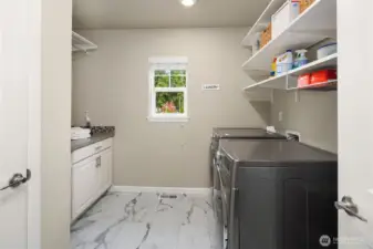 Such a nice laundry room with tons of storage.